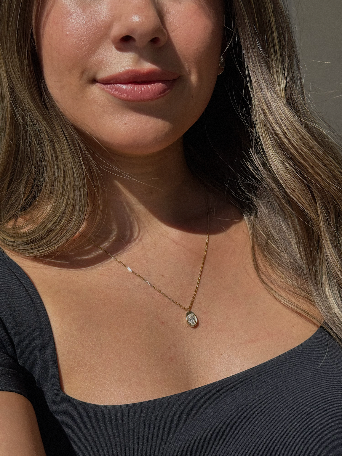 Custom jewelry design: bezel oval necklaced on model