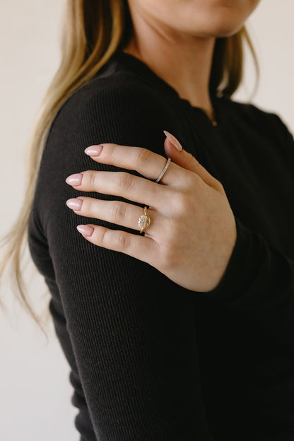 Image of custom engagement ring design on hand. Evelyn + Co. is one the top jewelers for custom engagement rings and custom jewelry design.